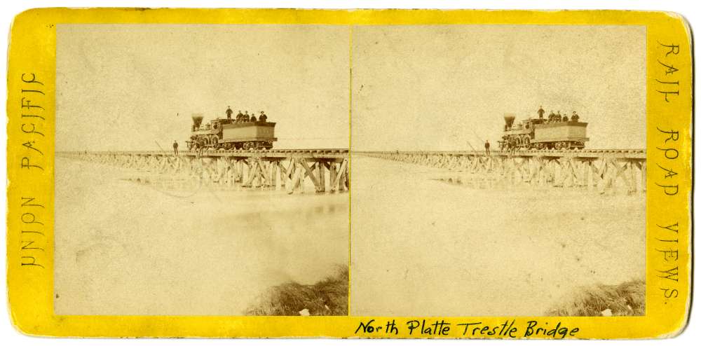 A stereo card showing the North Platte Trestle Bridge and Locomotive #54